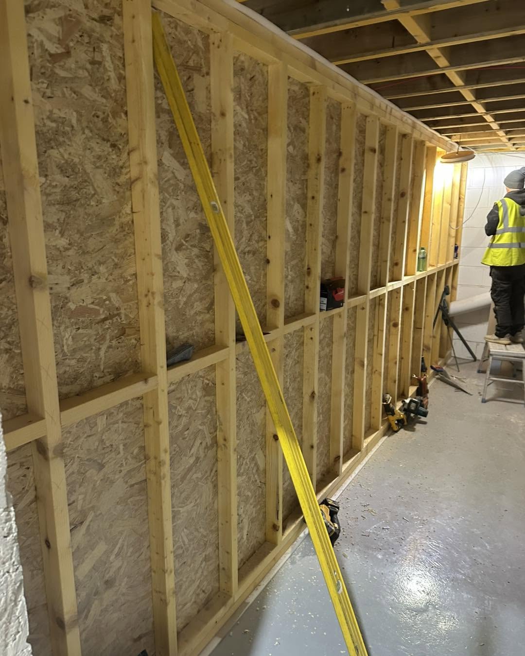 Timber-framed commercial partition wall during construction